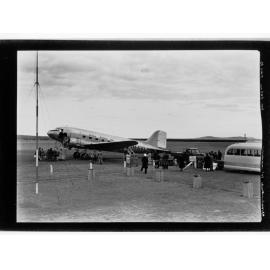 People standing around Guinea Airways Ltd plane