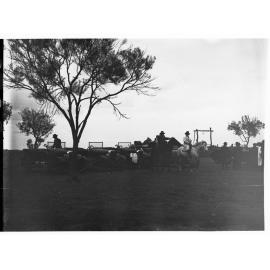 Parliamentary party on tour of Far North in Austin cars (government cars) - shows men on horses