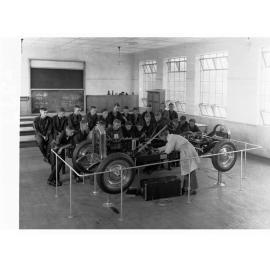 Technical College Showing Students Gathered Around an Automobile