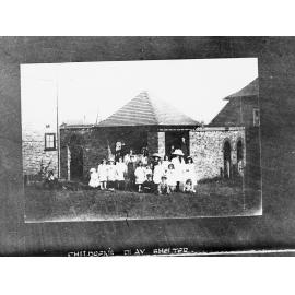 Exterior view of children's play shelter,  shows group of children