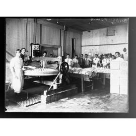 Men working in factory making butter