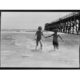 Two children in water near Largs pier