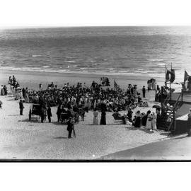 Brighton beach showing crowds of people, and horse and cart