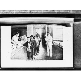 Children receiving bathing suit and towel at booth check,  at children's play shelter