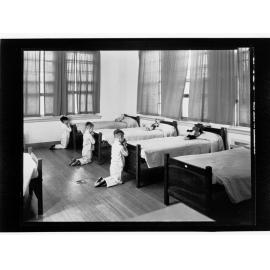 Children's Welfare Department - boys kneeling praying at foot of beds