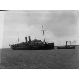 Steamship "RMS Maloja" being tugged by tug boat - Outer Harbour