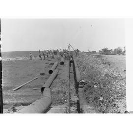 Happy Valley Waterworks - men laying pipes