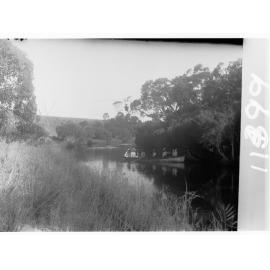 View on Hindmarsh River - Victor Harbor, with people in  rowboat