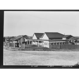 Whyalla - woman and child standing at the corner near some houses
