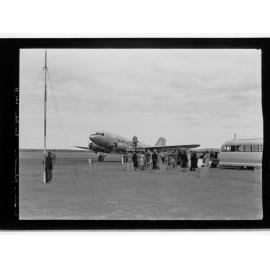 People standing around Guinea Airways Ltd plane