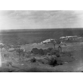 Farming land showing farm buildings, rain water tank and wind mill