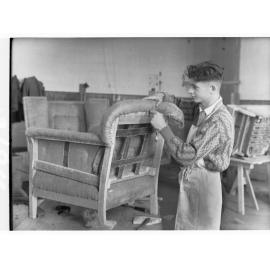 Students upholstering chair at trade school