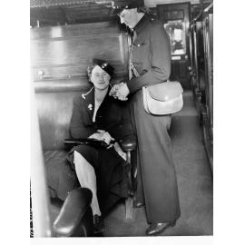 South Australian Railways female ticket collector showing female passenger
