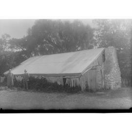 Hut with two men standing in front