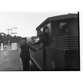 Railway conductor near locomotive, Belair