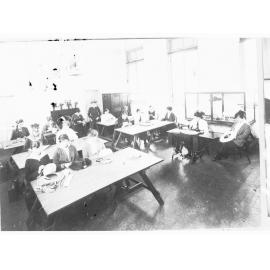 Girls in a class learning millinery skills