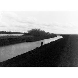 Man standing alongside South Eastern Drainage channels