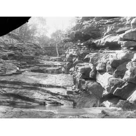 Rocky cliffs showing small stream