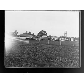 View of farm buildings and cows in a paddock
