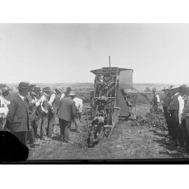 Men Observing a Mechanical Ditch Digger at Work