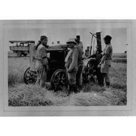 Men around harvester