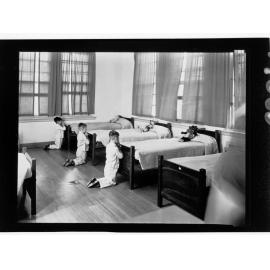 Children's Welfare Department - boys kneeling praying at foot of beds