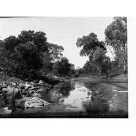 Erengunda creek, Flinders Ranges, man crossing river in horse drawn carriage in the distance