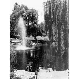 Botanic gardens view with water spouting in foreground