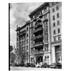 Liberal Club building North Terrace decorated for state centenary, automobiles parked outside