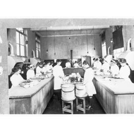 Girls in a class learning cooking skills