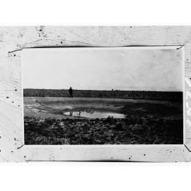 Man by a waterhole - location unknown