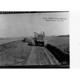 Agricultural Department, men checking wheat, showing tractor