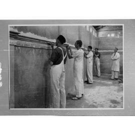 Reconstruction training school - Education Dept. - men plastering walls