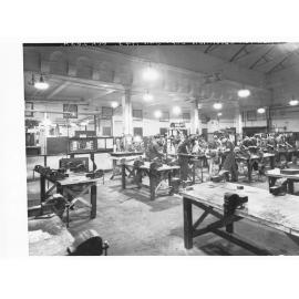 Grenfell Street Trades School Showing old lighting system in woodwork room, students at work