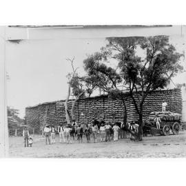 Northern Territory - wheat stacks and a carload of wheat waiting to be unloaded