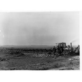 Construction of Happy Valley Reservoir dam wall  - showing small steam train