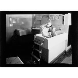 Children's Welfare Department - nurse bathing child