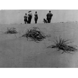Men Standing on a Sand Dune
