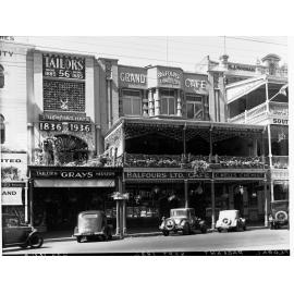 Buildings decorated on King William Street for State centenary, showing Balfours grand cafe, automobiles parked in street