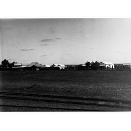 Parliamentary party on tour of Far North in Austin cars (government cars) - shows Oodnadatta railway line and houses