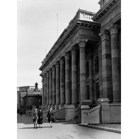 Front of Parliament House looking towards railway station, people walking on the pavement also showing