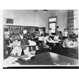 Children Reading at Tables in a School Library