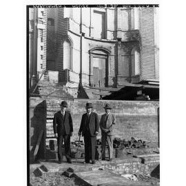 Three men outside Parliament House during construction of extension