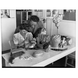 Women Making a Wig Being Supervised by a Man