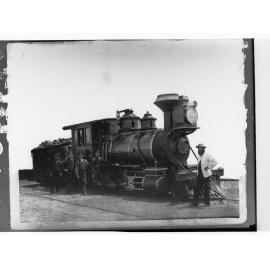 Steam locomotive showing railway employees