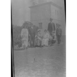 Family group sitting in front of a lighthouse