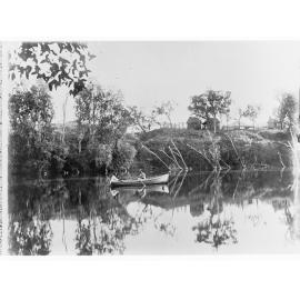 Two men in a rowboat on a river - Northern Territory