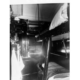 Sleeping compartment in a railway carriage showing bunk beds; and cupboard.
