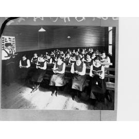 Schoolgirls Reading in Classroom