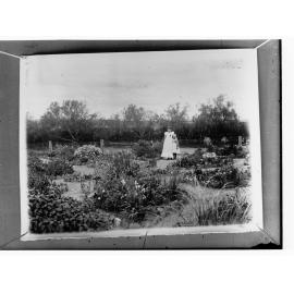 Mother and child standing near fence in garden